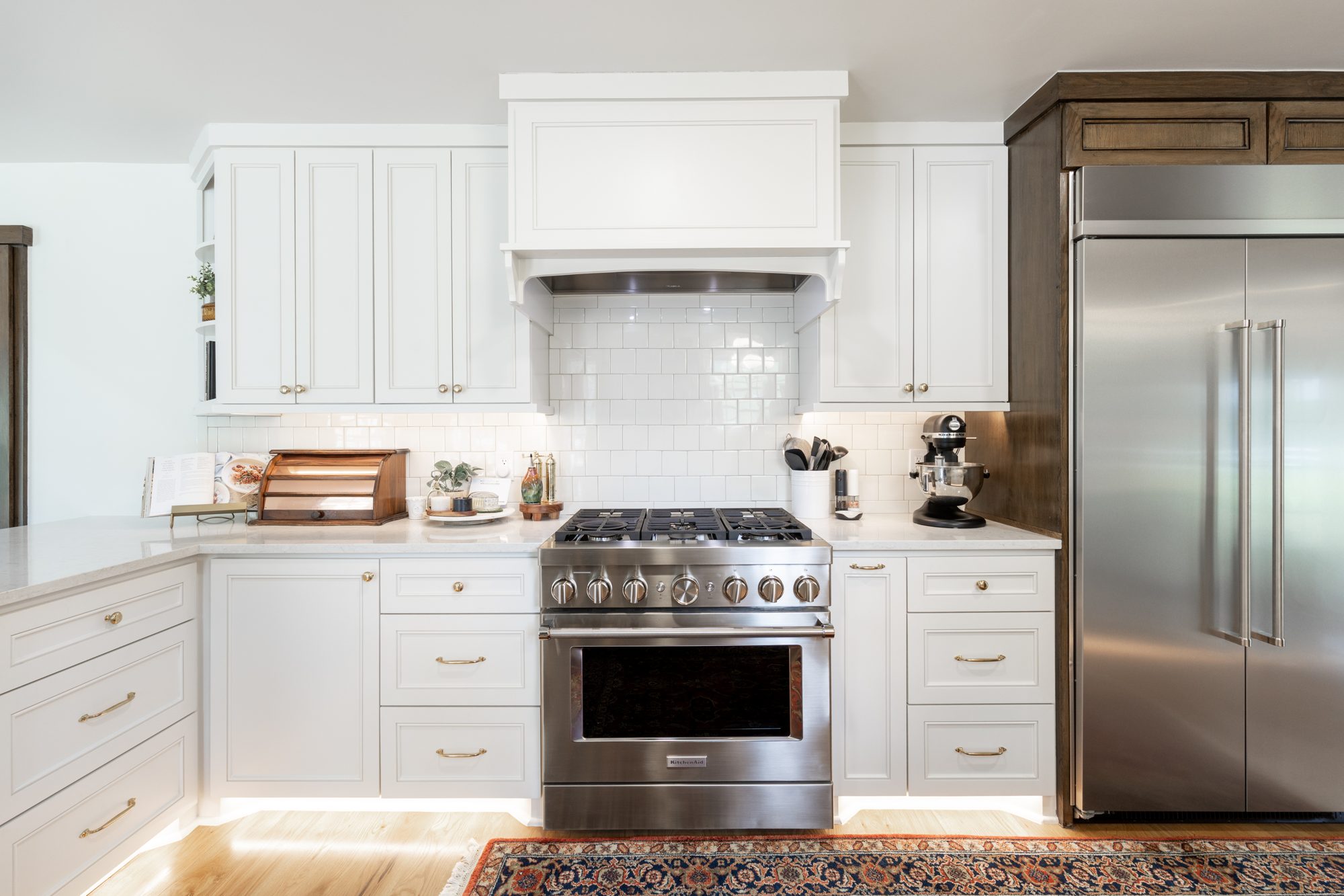 Warm contemporary kitchen with custom cabinetry and a stone island